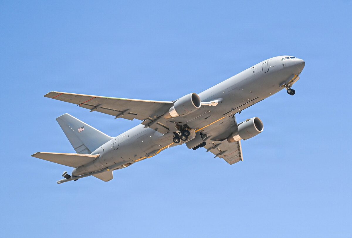 A U.S. Air Force KC-46 Pegasus taking off from a runway.